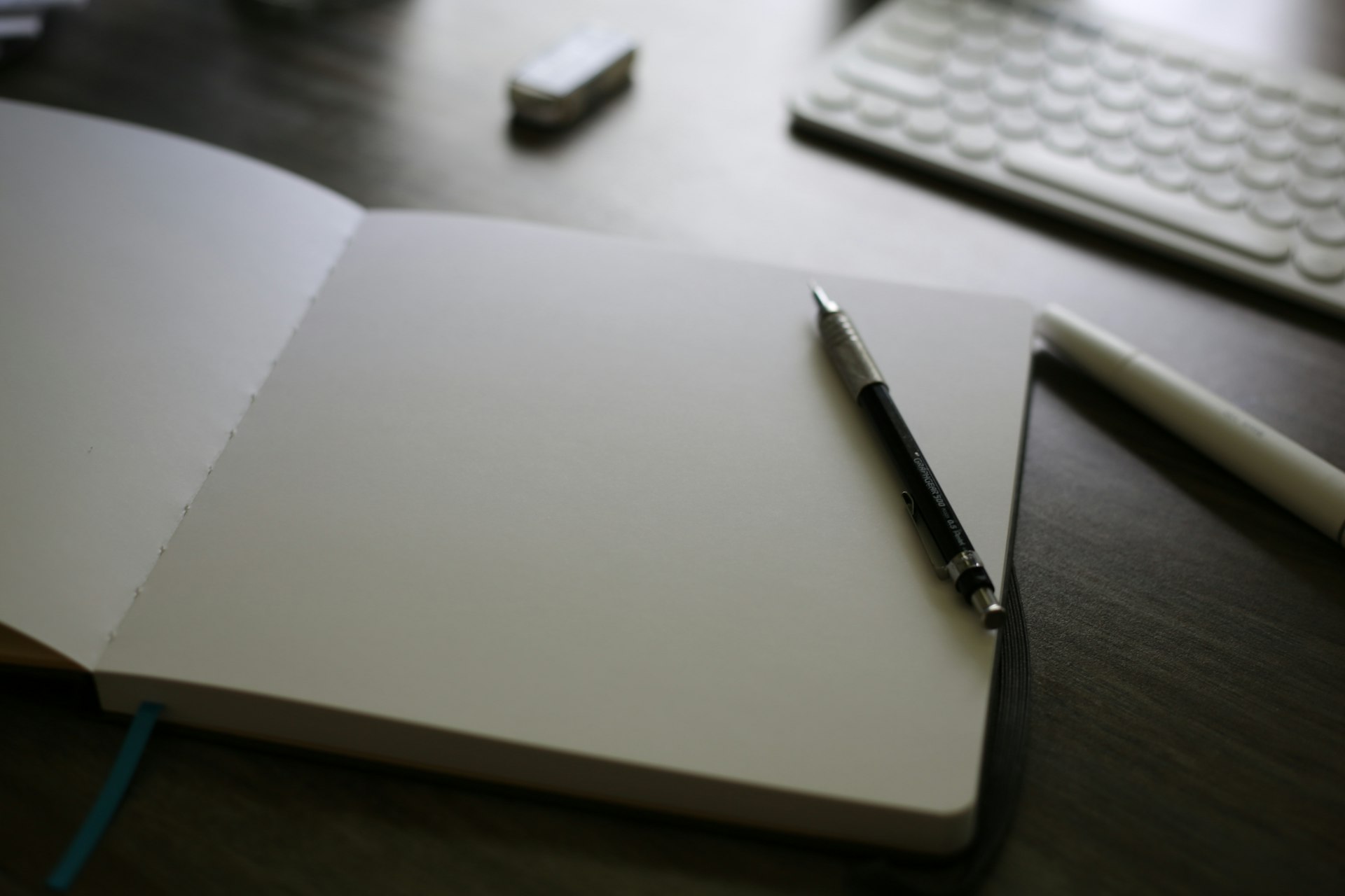 An open notebook with a pen on top of it